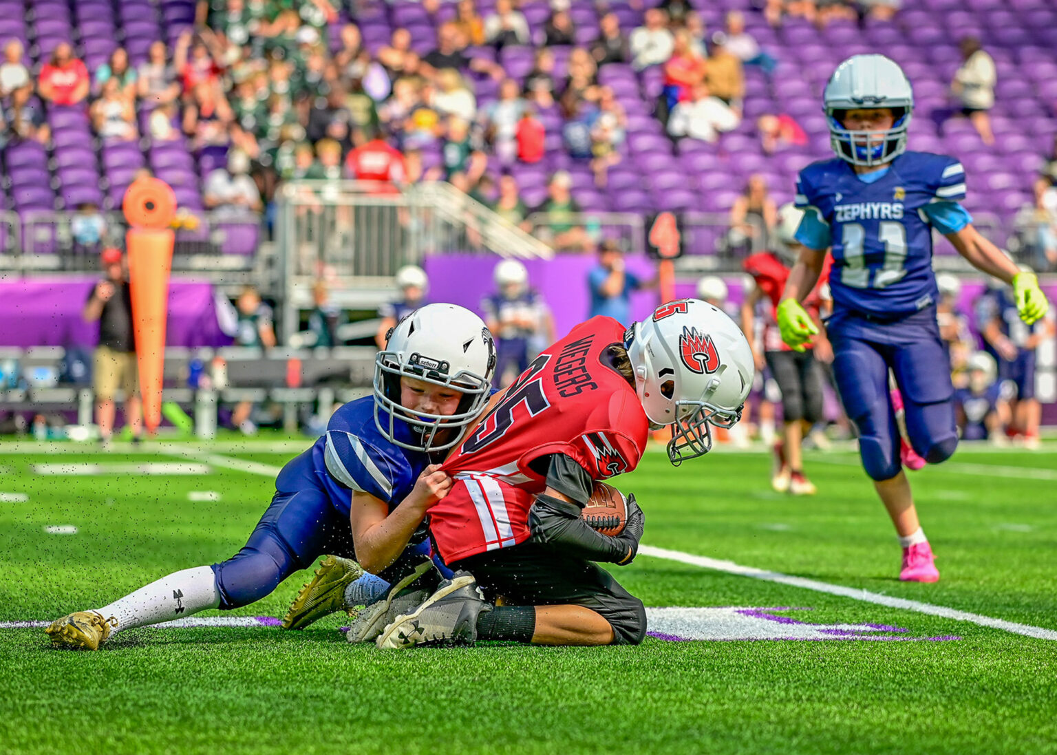 Youth football players in a stadium, sport photography Minneapolis