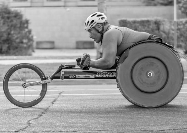 Wheelchair racer on the course, black and white adaptive sports photography