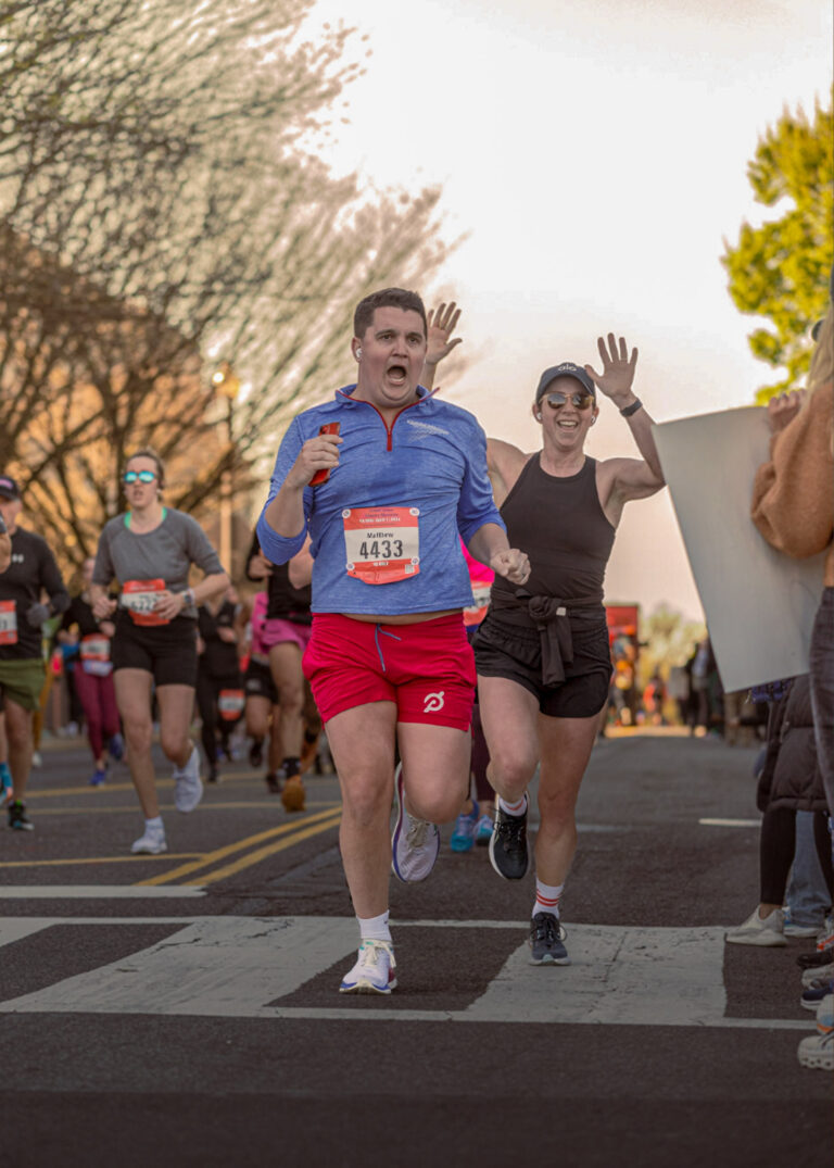 Runners cheering along a race course, event photography Minneapolis