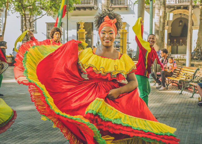 Dancer twirling a red ruffled skirt at a street festival