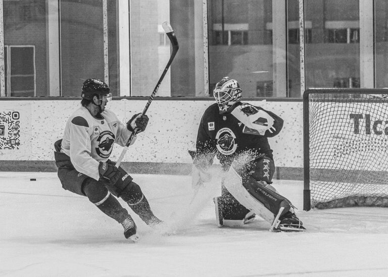 Hockey player skating past the goalie in a practice drill