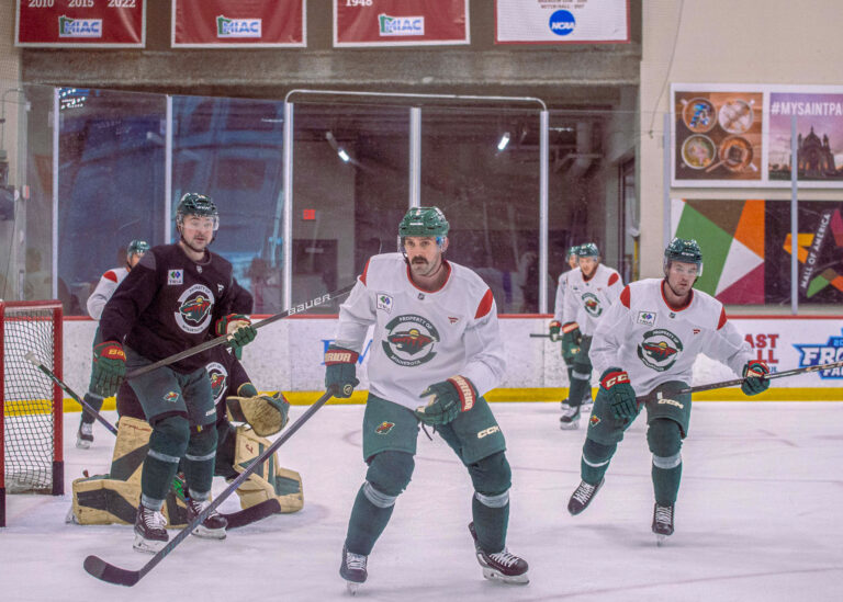Hockey players battling along the boards, sport photographer Minneapolis