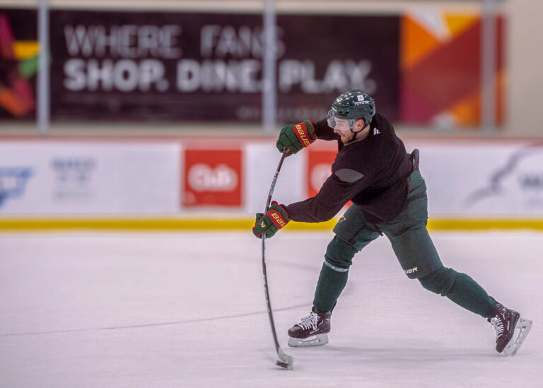 Hockey player taking a shot on the ice, Minneapolis sport photography