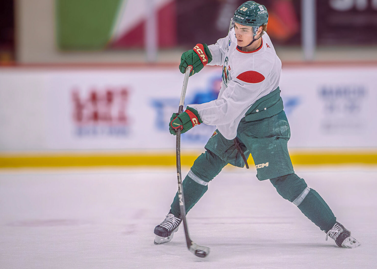 Hockey player skating with the puck, hockey photography Minneapolis