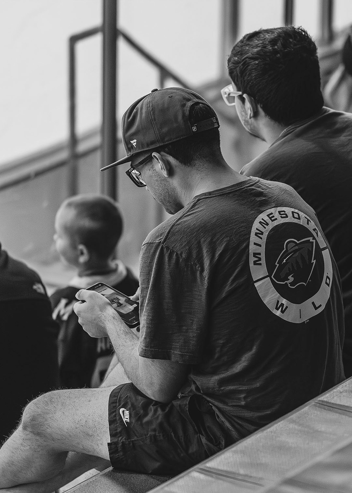Young fan in a hockey team shirt watching the game