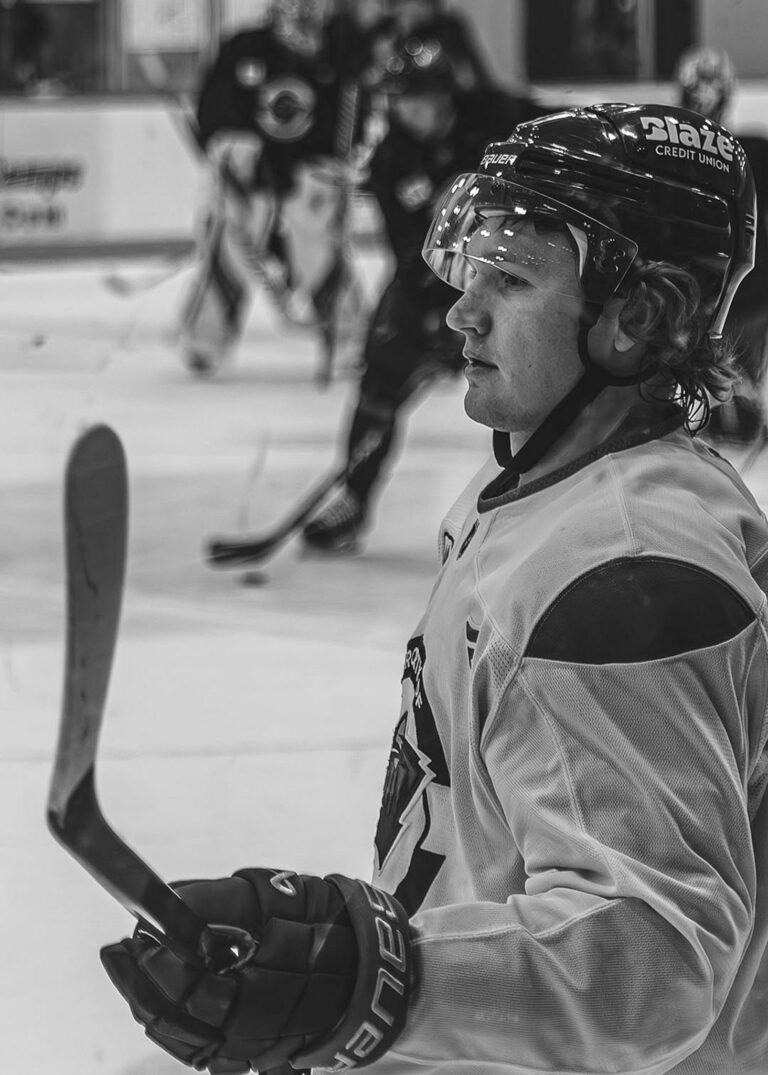 Hockey player helmet and stick in black and white