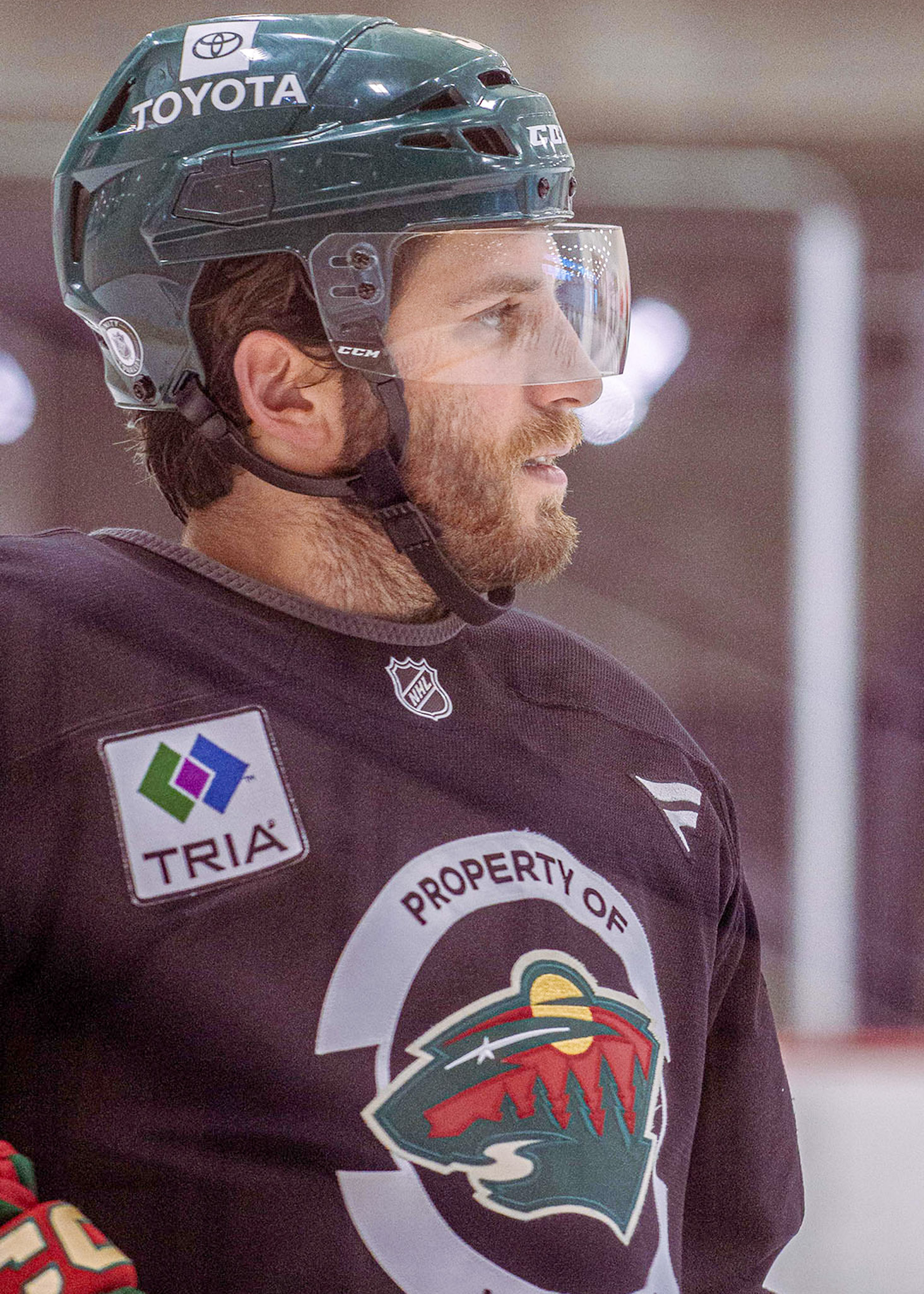 Close-up of a hockey player in a practice jersey and helmet