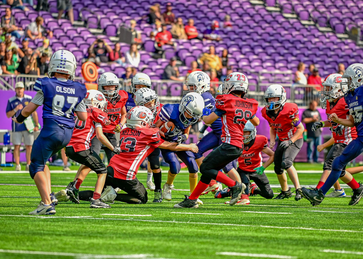Youth football team at the line of scrimmage in a stadium, Minneapolis sport photography