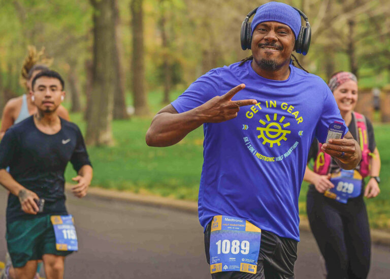 Runner celebrating on a race course, running photography Minneapolis