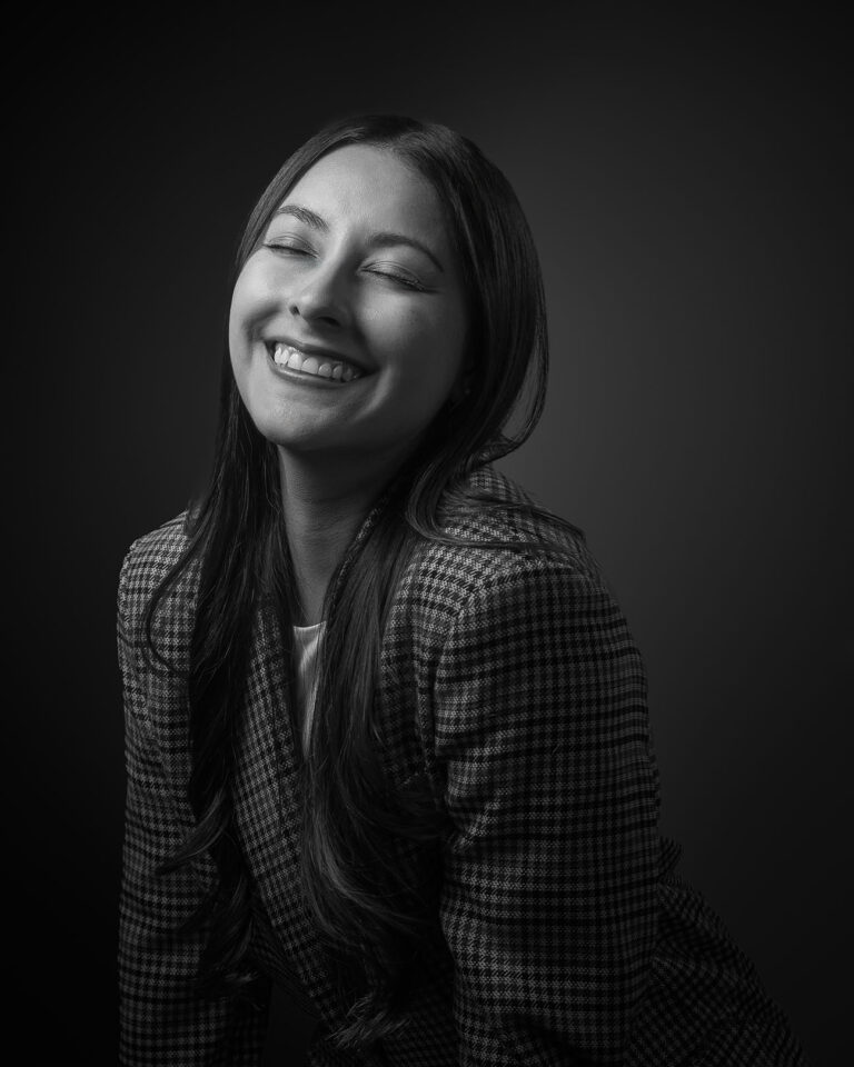 Smiling woman in a black and white studio portrait