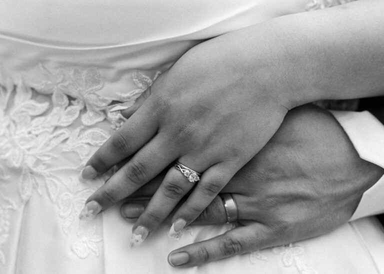 Hands of the bride and groom with wedding rings, in black and white